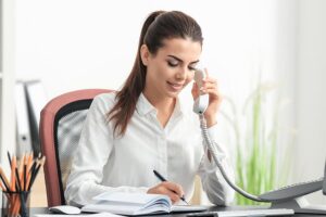 bigstock-Young-female-receptionist-talk-205987810